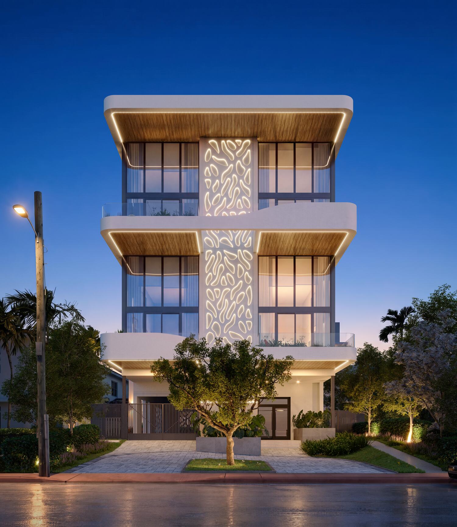 Fachada de Lullaby Residences al anochecer, con la celosía iluminada